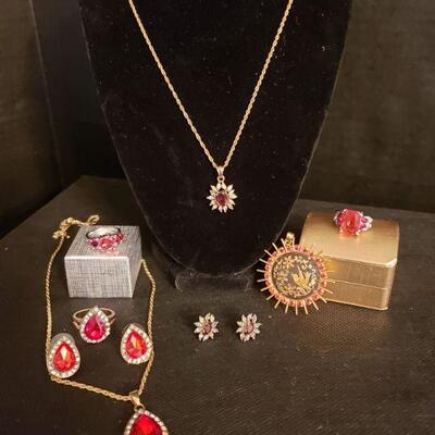 https://ctbids.com/#!/description/share/721061 Collection of red gemstone jewelry. Two rings are sterling silver and approximately size...