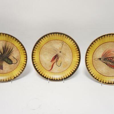 1126	THREE 12 1/4 IN POTTERY PLATES W/ FLY FISHING LURE DECORATION. TWO OF THE PLATES HAVE SMALL RIM CHIPS 

