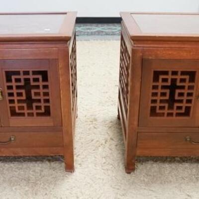 1149	PAIR OF SQUARE CARVED LAMP STANDS THE HAVE GLASS TOPS TWO DOORS & ONE DRAWER & FRET WORK SIDES. THEY HAVE SCENIC CARVING ON THE...