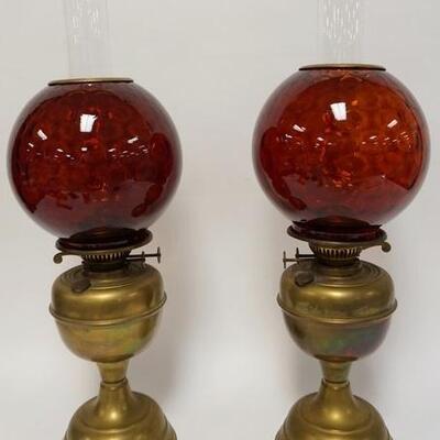 1053	PAIR OF ANTIQUE BRASS KEROSENE LAMPS W/RUBY GLASS HONEYCOMB GLOBES, BURNERS MARKED DUPLEX ENGLAND, 23 IN HIGH
