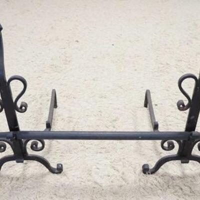 1151	PAIR OF LARGE WROUGHT IRON ANDIRONS W/ CROSS BAR. 28 IN H 24 IN DEEP THE CROSS BAR IS 46 IN W 
