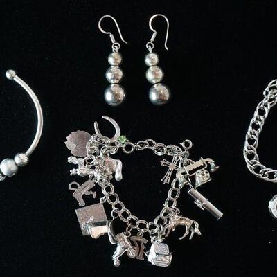 1258	STERLING SILVER CHARM BRACELET 9 OF 15 CHARMS MARKED STERLING, STERLING CHARM BRACELET WITH CHARM MARKED * SKIDMORE COLLEGE 1911 -...