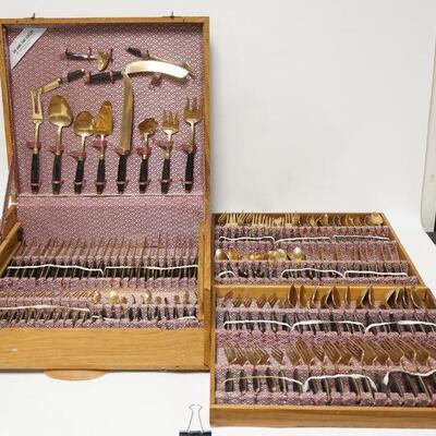 1145	LARGE THAI BRASS FLATWARE SET IN A WOODEN CARRYING CASE HAS NUMEROUS SERVING PIECES 
