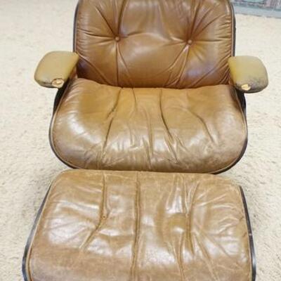 1152	EAMES STYLE ARM CHAIR W/ MATCHING OTTOMAN W/ VINYL UPHOLSTERY ARM CUSHIONS HAVE DAMAGE.
