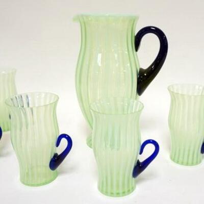 1040	FENTON GREEN OPALESCENT STRIP 7 PIECE LEMONADE SET WITH APPLIED COBALT BLUE HANDLES. PITCHER IS 10 IN HIGH, TUMBLERS ARE 5 1/4 IN...