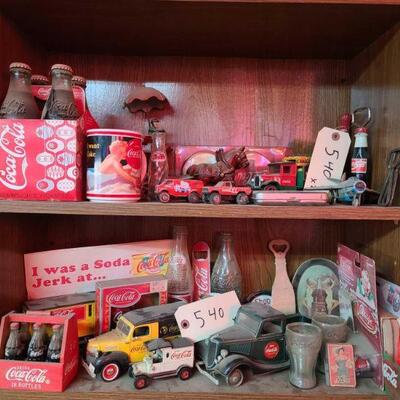 540	
Coca-Cola Collectables
Coke Bottles. Toy Trucks. Toy Cars. Bottle Openers. Shot Glasses. Coasters. Ornament.