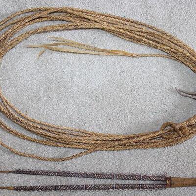 Vintage 40â€™ Rawhide Lariat.  Also shown is a Carved Wooden Handmade/Decorated what appears to be some sort of Tribal Weapon.