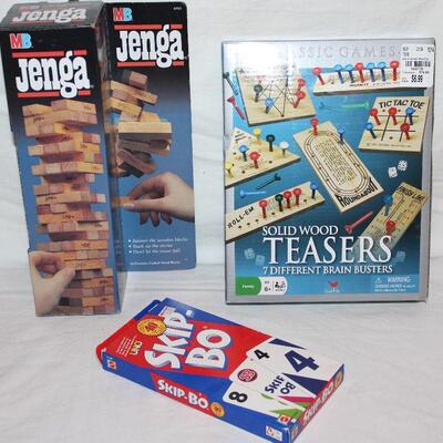 1986 Jen ga, Skipbo card game, and solid wood Teasers with 7 brain busters