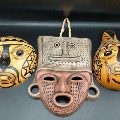 Three hand crafted masks from Chile and two vicuna furs. Round Gourd: 6.5