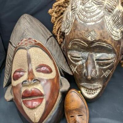 Owner states that these three beautifully hand crafted masks were hand carried back from Africa. Large one on left: 14