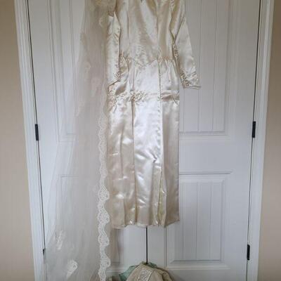Hand made vintage wedding dress around a size small. Includes two head pieces the one that matches the dress has the tulle pulled off and...