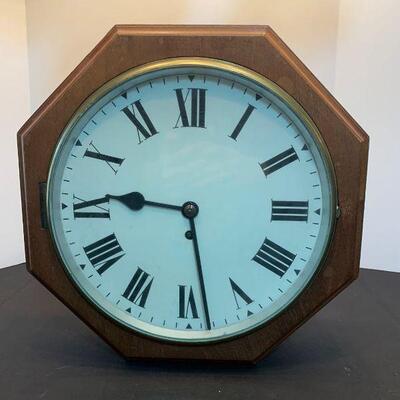 A vintage wooden wall clock with glass front hinged face. Roman numerals on the face. No name or makers mark found....