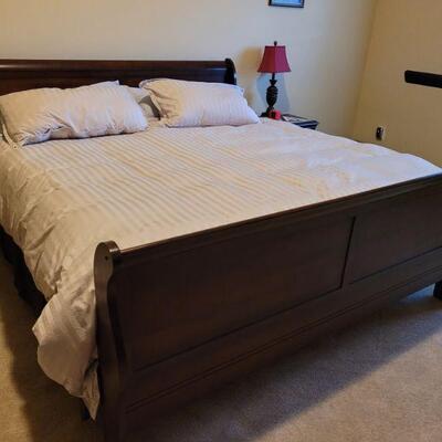 King size sleigh bed complete with mattress pad. Also includes sheets and down comforter with stripe duvet and matching pillows. The head...