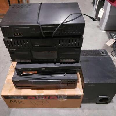 #1174 â€¢ Three Kenwood Multi-Media Players, One Sony VHS Player, One Aiwa Speaker, and more