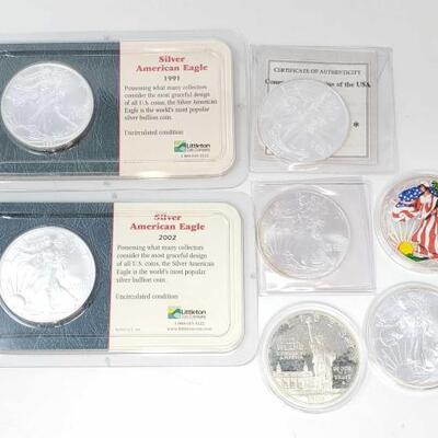 #604 • 7 1oz Silver American Eagle Coins
