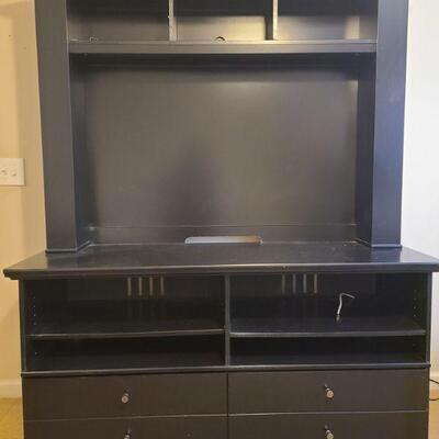 Media center in black comes in two separate pieces. Top piece has a total of nine shelves. Three across top and three on each side....