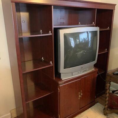 A Sauder Entertainment center with older RCA TV included. Featuring multiple shelves and a storage cabinet below with brass knobs for...