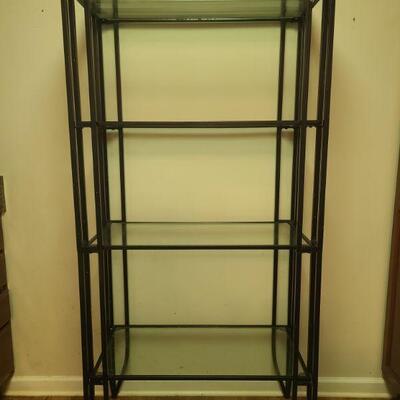 Metal frame with glass shelves in good condition. Measures 32