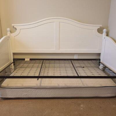 White framed day bed with spring base is in decent condition. Bed measurements are 81