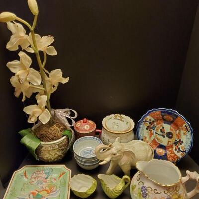 Asian decor lot includes a ceramic elephant 7", silk orchid 24", jars, plates and more....