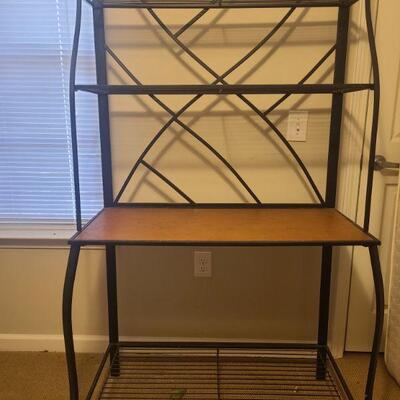 Four shelf metal storage rack. One shelf is made of wood. Measures 37