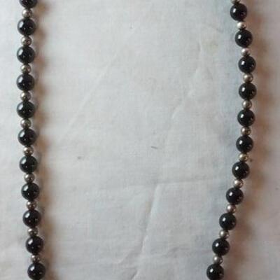 1002	TIFFANY & CO ONYX AND STERLING SILVER BEADED NECKLACE 29 IN LONG. APPROXIMATE TOTAL WEIGHT WITH STONES 2.583 OZT
