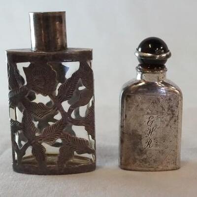 1003	2 STERLING SILVER OVERLAY PERFUME BOTTLES, 1 MARKED MEXICO WITH STERLING LID, 1 MARKED WELLS STERLING SILVER WITH ONYX AND STERLING...