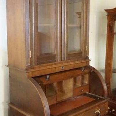 1066	VICTORIAN CYLINDER ROLL TOP SECRETARY W/BOOKCASE TOP, GLASS DOORS ARE BEVELED, 32 3/4 IN WIDE X APPROXIMATELY 95 IN HIGH
