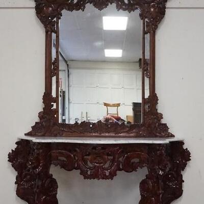 1065	HEAVILY CARVED MARBLE TOP CONSOLE W/LARGE HANGING MIRROR, APPROXIMATELY 57 IN WIDE X 30 1/4 IN HIGH, MIRROR IS APPROXIMATELY 45 IN X...