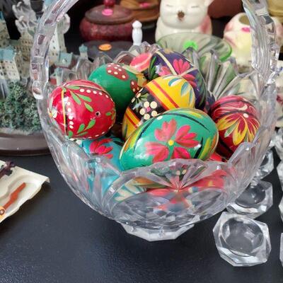 Glass bowl with a bunch of wooden, hand painted eggs