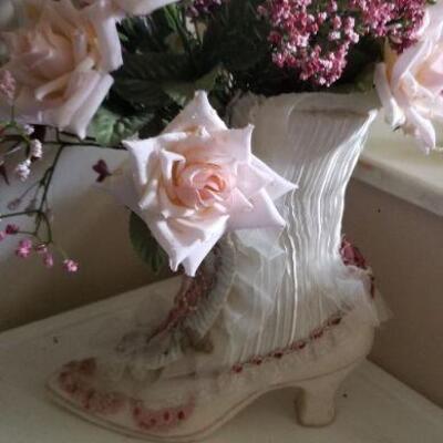 Very different ceramic cowgirl boot with artificial flowers