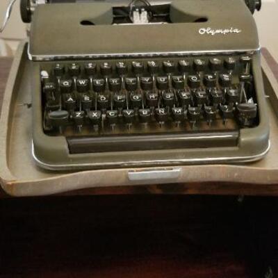 Olympia typewriter with a metal carrying case, good condition, shows very little age use