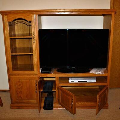 Solid wood entertainment center has style and plenty of room for storage and display.
