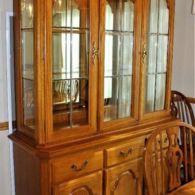 Beautiful oak hutch features glass shelves with lighted display.  It's also in excellent condition.