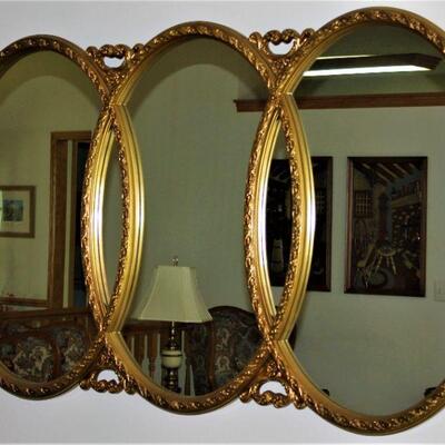 This ornate, triple oval mirror makes a beautiful wall hanging.