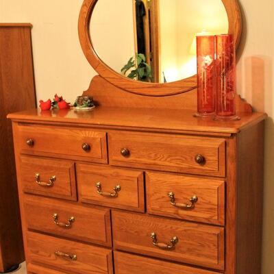 This oak, nine-drawer dresser with mirror by Bassett is in excellent condition.