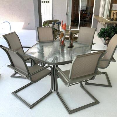 Outdoor hexagon table w/6 chairs. Table has patterned glass top and measures 55