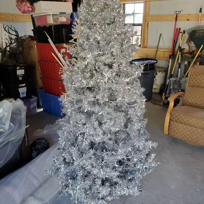 Beautiful 6.5' silver pre-lit Christmas Tree. Our client used to decorate this tree with all her red and black Georgia Bulldogs...