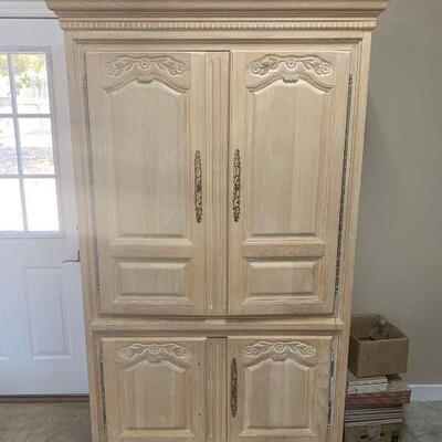This is an entertainment center cabinet with upper and lower pull out drawers and shelves. It features recessed cabinet doors on top that...