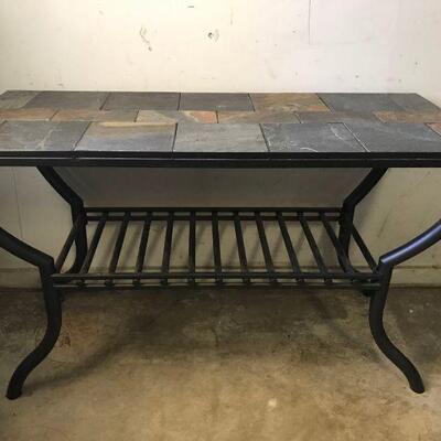 Slate topped metal sofa table with a dark brown finish. Table has a rack underneath for storage. Can be used indoor or outdoor.
Measures:...
