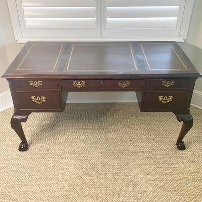 Leather top traditional desk with finished back measures 58" x 29"