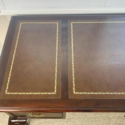 Leather top traditional desk with finished back measures 58" x 29"