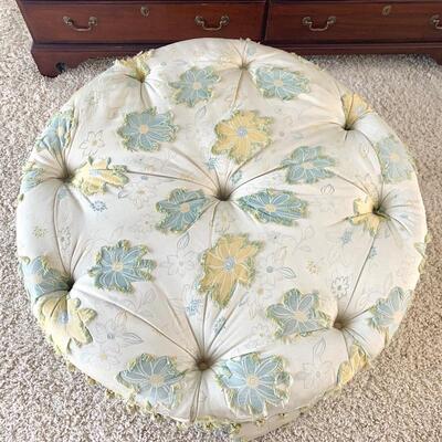 Floral tufted ottoman on casters measures 37