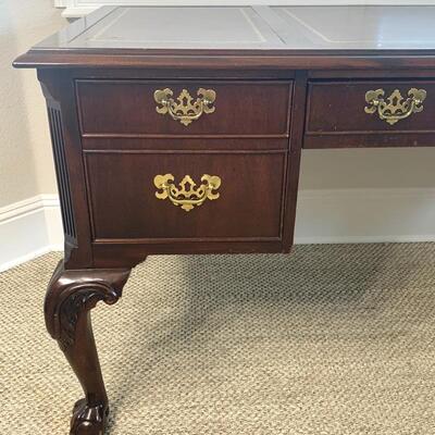 Leather top traditional desk with finished back measures 58" x 29"