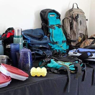 Camping gear, including backpacks, fanny packs, sleeping pads, sleeping bags, and other necessities.  Also a canoe, paddles, flotation...