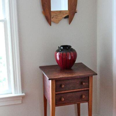 Small, antique, two drawer side table, mixed woods, ceramic pot, and mixed woods hand-crafted mirror.