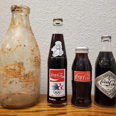 1068	

Large Milk bottle And 3 Commemorative Coca Cola Bottles
Large Milk bottle And 3 Commemorative Coca Cola Bottles