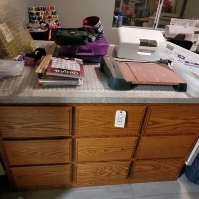 1300	

Craft Table With Quilting Supplies
Includes Quilting Books, Fabrics, X-Acto Cutter, And More