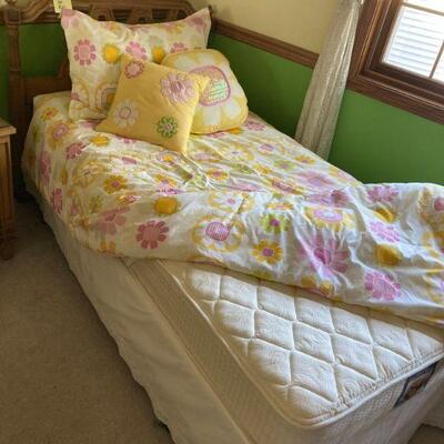 One of a pair of twin beds, one with 70's decor