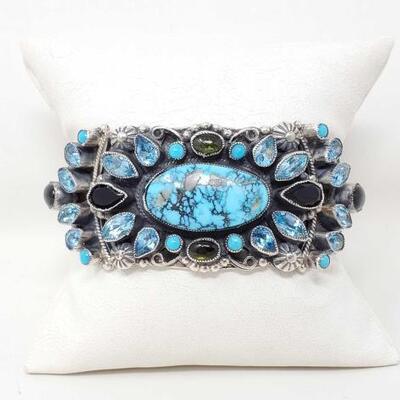 1100	

Native American Sterling Silver Cuff Turquoise And Semi Precious Stones by Leo Feeney
This Magnificent, Original Bracelet features...